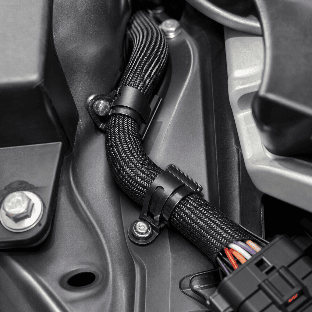 Wire harness designed for both space efficiency and mechanical protection Wire harness with protective sleeving in tight routing path